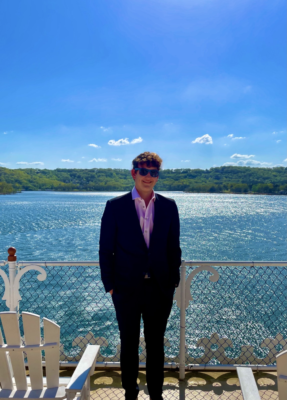 Connor dressed up near a scenic lake
