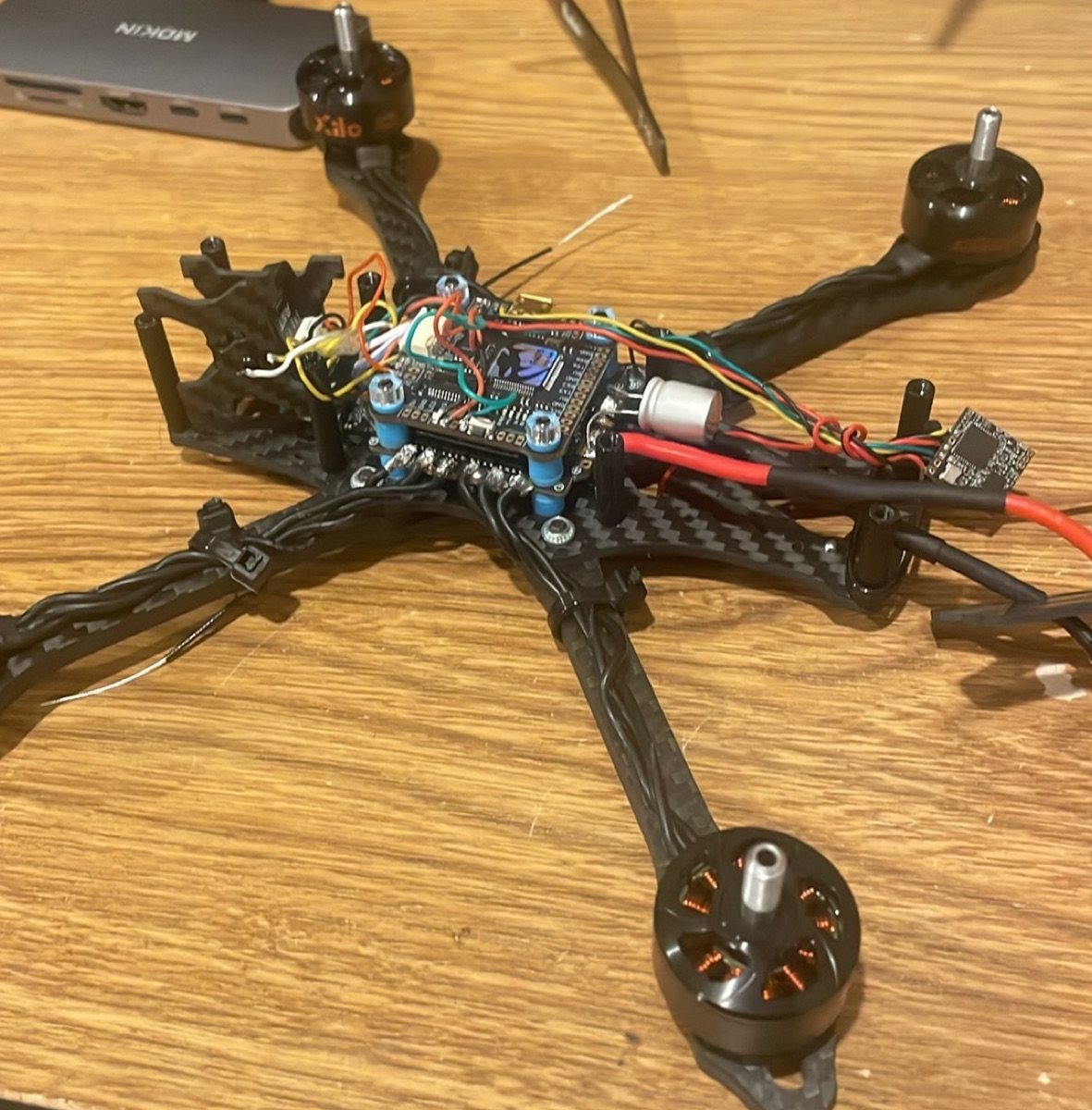 Custom FPV drone with its flight controller and wiring exposed