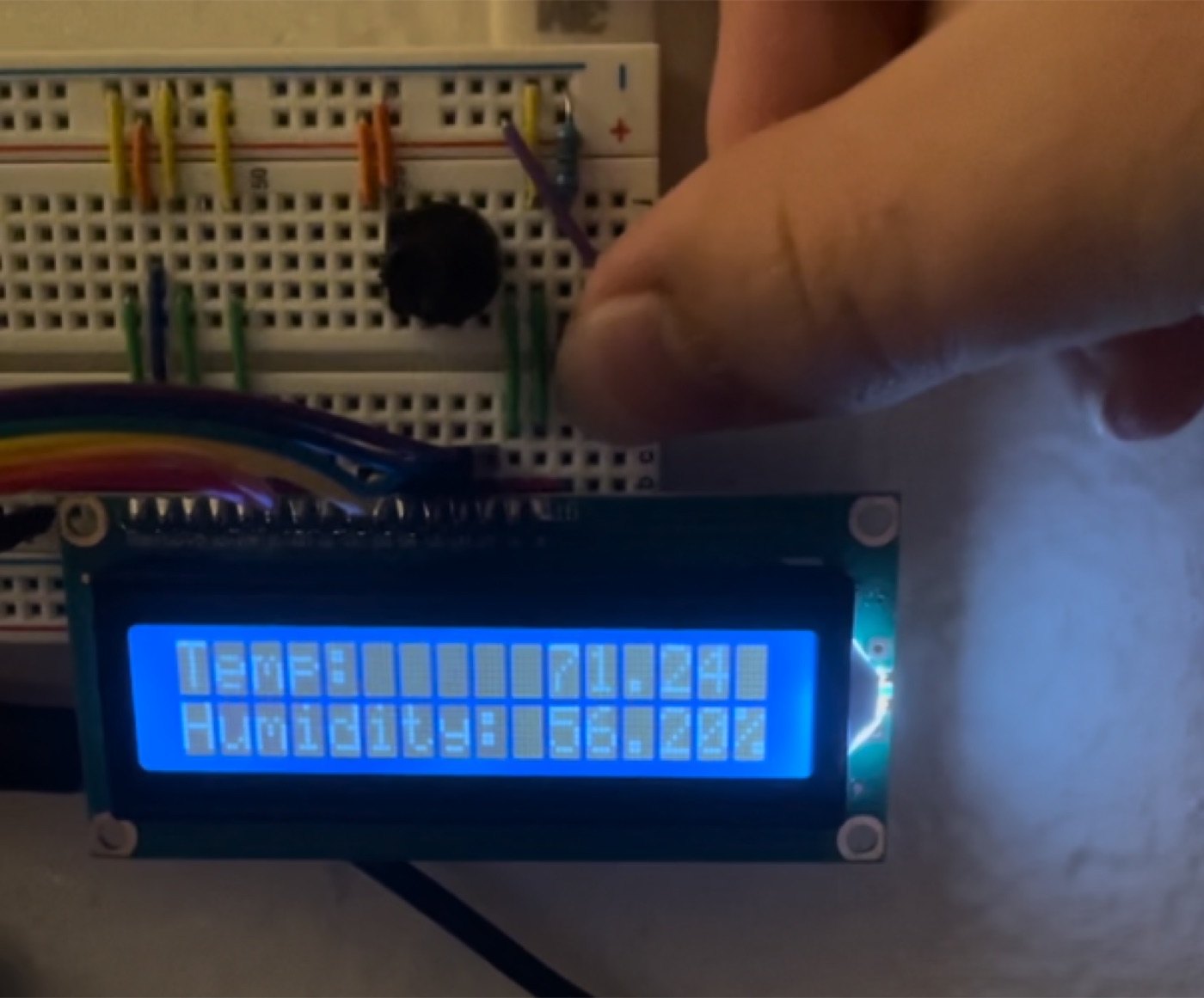 Breadboard plant monitor displaying temperature and humidity on an LCD